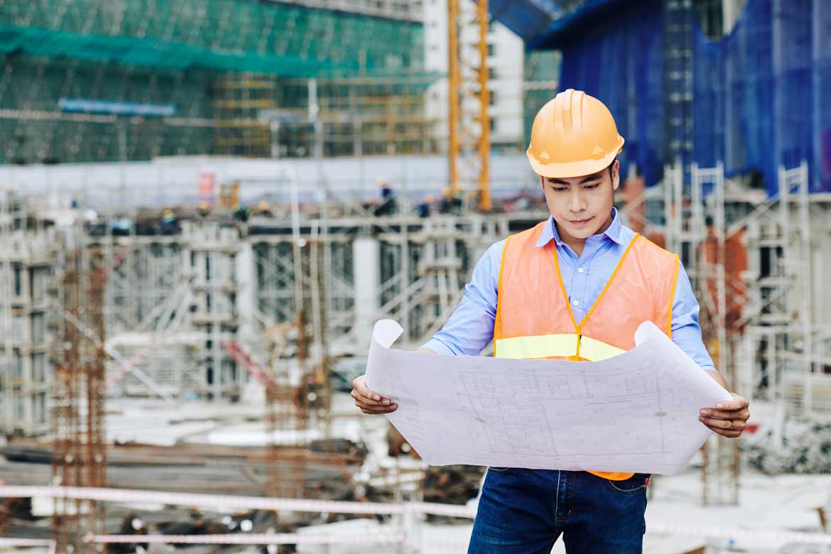 An engineer looking at his blueprint
